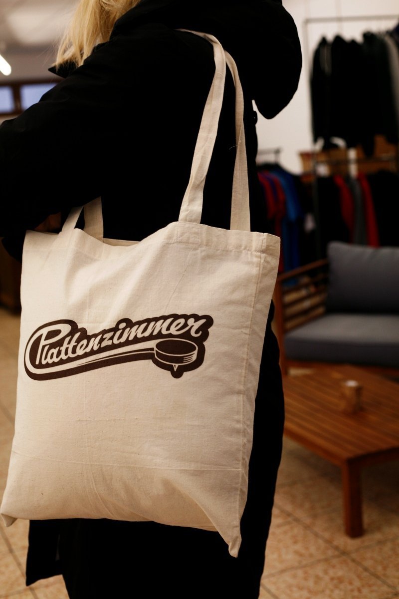 Naturfarbene Baumwolltasche mit beflocktem Schriftzug